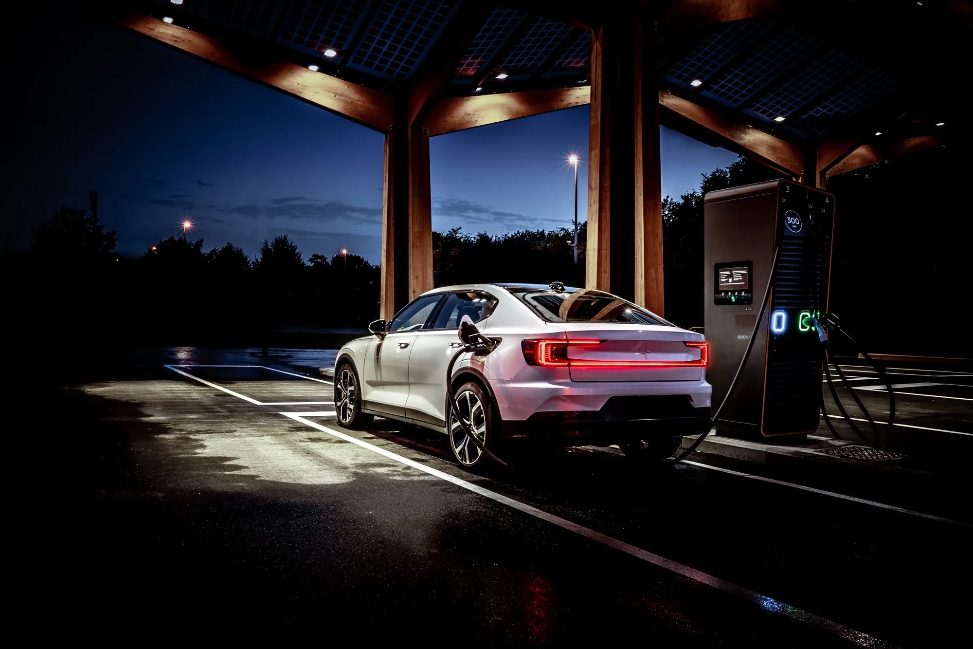 EV charging infrastructure engineered by SLC Energy Solutions, charging canopy at dusk